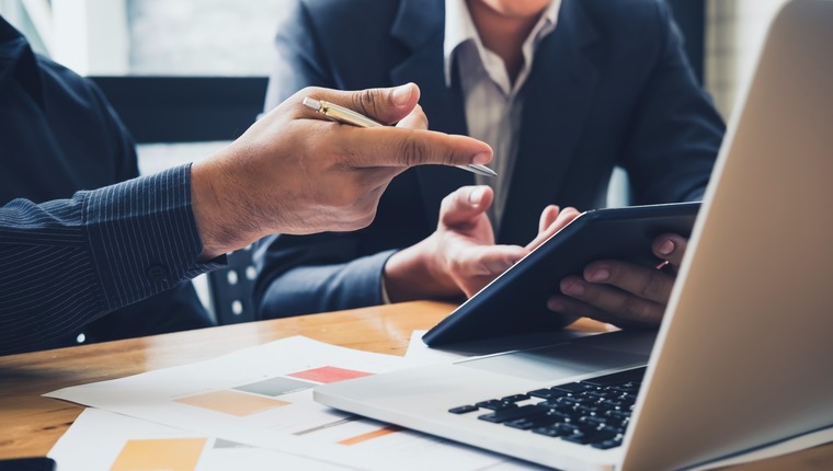 Businessman using a digital tablet to discuss information with s